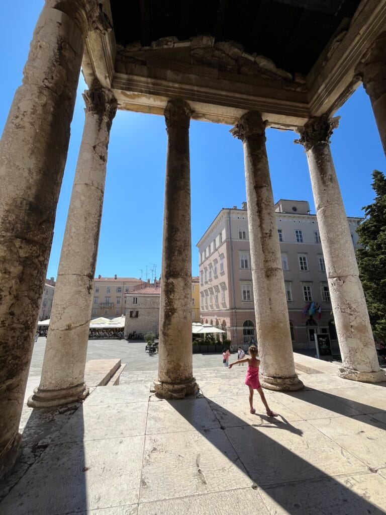 Columns of Temple of Augustus with sun shining through in Pula, Croatia